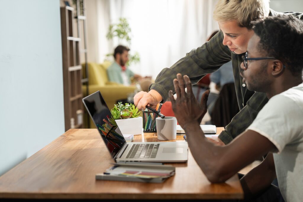 Two colleagues having a peer mentorship session in the office.
