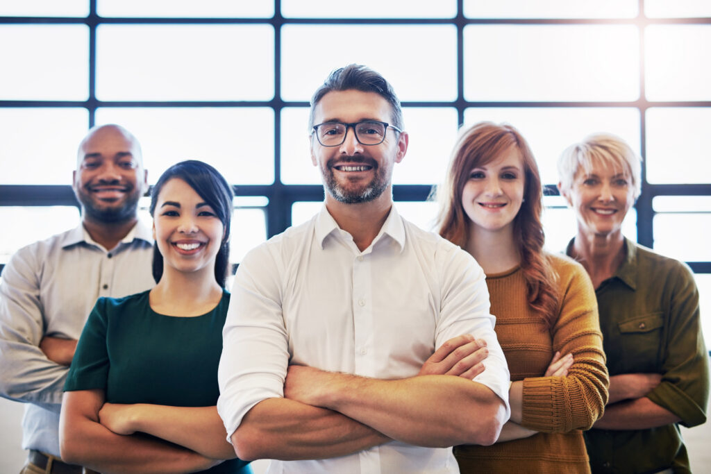 Confident group of professionals standing together, representing strong team leadership and unity in the workplace.